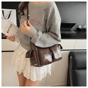 Brown oil wax leather shoulder bag featuring multiple pockets and vintage workwear style