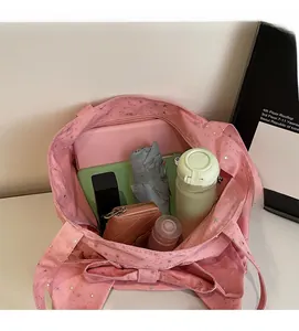 Detailed interior of a pink tote bag showing spacious capacity for tablets and essentials