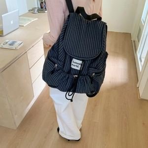 Plaid canvas backpack with drawstring closure and flap design for casual daily use