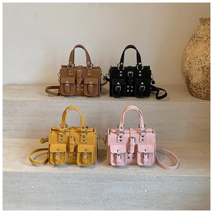 Group shot of four multi-pocket utility shoulder bags in brown, black, yellow, and pink