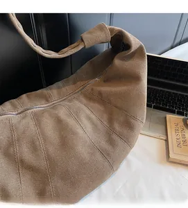 Detail of coffee canvas hobo bag showing vertical pleated texture and sturdy fabric