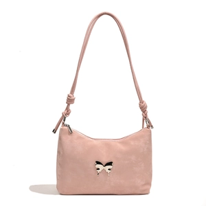 Pink matte shoulder tote bag with silver butterfly metal ornament and knotted strap detail