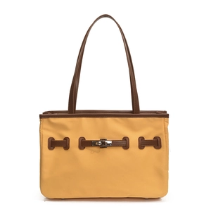 Yellow nylon tote bag with brown leather trim and silver metal twist lock on white background