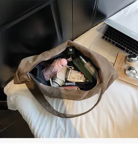 Spacious interior of the large canvas crossbody bag showing daily essentials storage