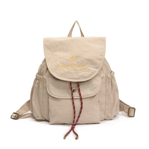 Minimalist beige drawstring canvas backpack with yellow embroidery and flap pockets