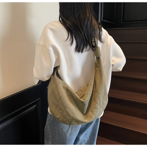 Detail of olive green canvas hobo bag with unique knot shoulder strap and decorative stitching