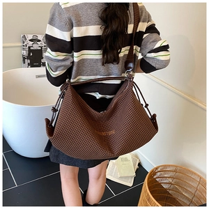 Brown houndstooth hobo bag with drawstring details and OWOSTUDIO logo shown from the back