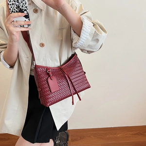 Deep red woven crossbody bag with drawstring detail and adjustable strap for women