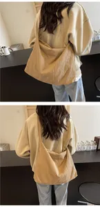 Détail d'un grand sac bandoulière plissé en tissu texturé avec une large bandoulière