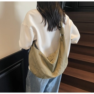 Olive green canvas hobo bag showing large capacity and knotted strap detail on back view