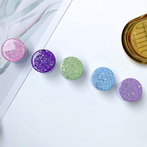 Close-up of sparkling galaxy phone grips with glitter sequins and moon star motifs