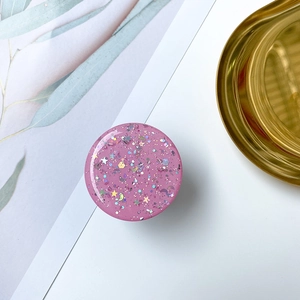 Macro shot of purple resin phone grip with star and moon sequins in a starry sky style