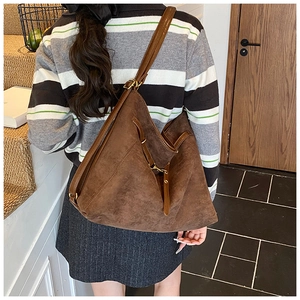 Détail d'un grand sac cabas en cuir mat marron foncé montrant sa texture et sa capacité