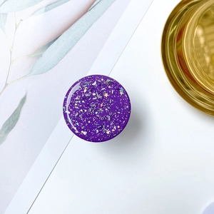 Macro shot of purple starry sky collapsible phone grip with glitter and resin finish