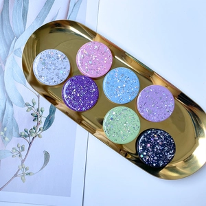 Close-up of glittery star and moon pattern phone sockets in multiple colors on a tray