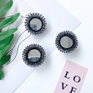 Close-up of three sparkling rhinestones and mirror surface folding phone socket holders