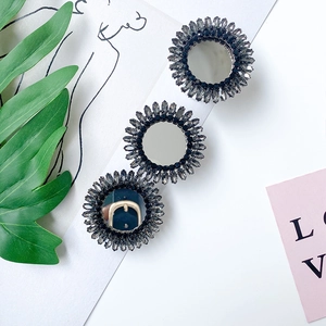 Detailed view of luxury rhinestone phone grip with sunflower mirror design and black crystals