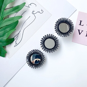 Macro shot of three luxury sunflower phone grips with grey rhinestones and mirror surface