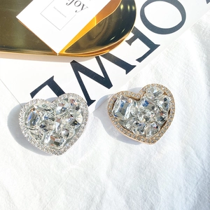 Luxury heart-shaped crystal phone grip stand in gold and silver finish with rhinestones