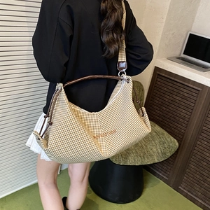 Chic yellow checkered hobo bag with brown leather handle and drawstring detail