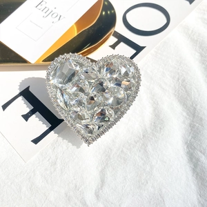 Detailed view of luxury heart-shaped rhinestones on a foldable phone stand grip