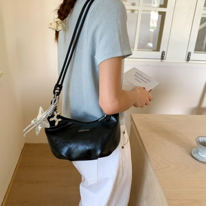 Chic black crescent hobo bag with star and balloon dog charms for casual fashion wear