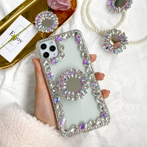 Close-up of luxury rhinestone-encrusted phone case with foldable ring stand and crystal accents