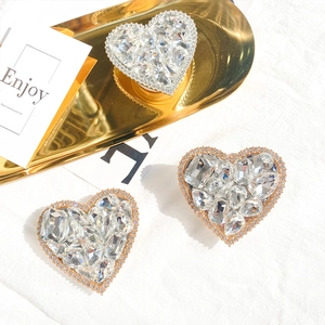 Close-up of luxury heart phone grips with sparkling rhinestones in silver and rose gold