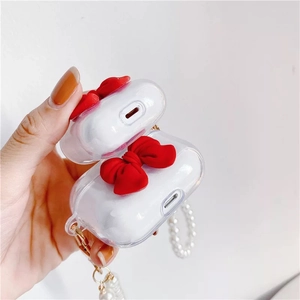 Clear TPU AirPods case with a 3D red bowknot and elegant white pearl bead strap