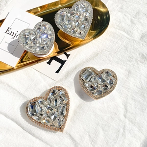 Macro shot of luxury heart-shaped crystal phone sockets on a golden metal tray