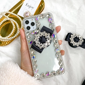 Detailed close-up of luxury rhinestone phone case with elegant black ribbon bow holder