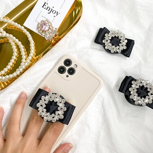 Detail of luxury rhinestone bow phone socket with black satin and pink crystal accents