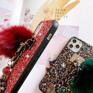 Glittery iPhone case with red luxury rhinestones, metal chain and large faux fur pompom