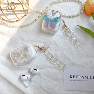 Detail of transparent AirPods case with iridescent butterfly and pearl chain strap