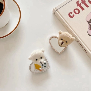Detail of plush bear heart phone socket with sparkling rhinestones in cream tones