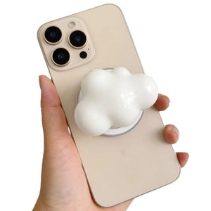 White cloud-shaped expandable phone socket grip on a smartphone with a glossy finish