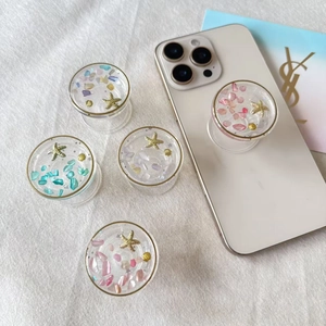 Starfish and seashell phone grip set with colorful stones in golden ocean style