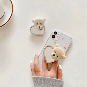 Cute plush bear phone grip with rhinestone heart mirror on a clear phone case