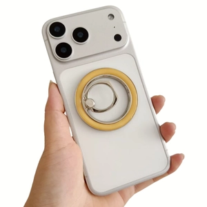 Detail of a white matte phone case with silver metal ring stand and yellow accent ring