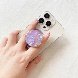 MagSafe phone grip with purple shell pattern and iridescent resin finish on a smartphone