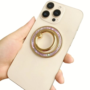 Detail of magnetic shell texture phone ring holder with gold metal double ring stand
