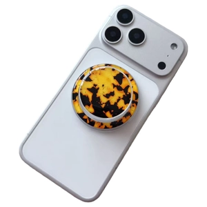 Macro shot of circular magnetic phone holder with amber tortoiseshell shell pattern
