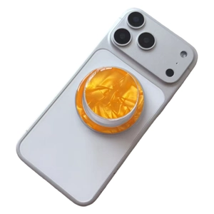 Detail of magnetic phone socket with orange marble texture on a white smartphone
