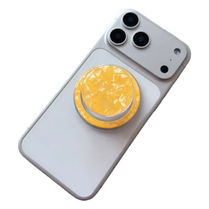 Close-up of yellow shell-textured magnetic phone socket on a white phone case