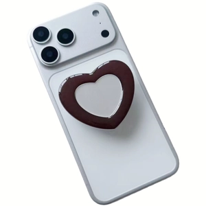 Brown heart-shaped mirror phone grip stand attached to white smartphone back
