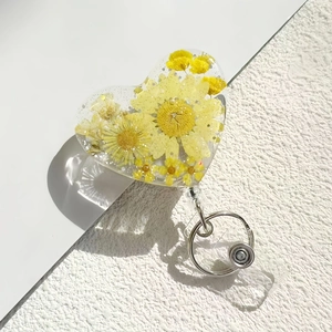 Retractable heart shaped resin badge reel with yellow dried flowers and gold glitter