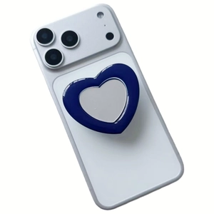 Detail of heart-shaped phone grip with navy blue rim and silver mirror surface on a device