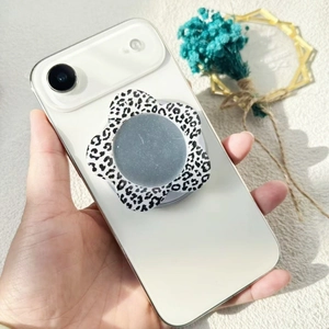 Flower shaped leopard print magnetic phone stand with a circular vanity mirror attachment