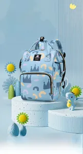Close-up of baby diaper backpack with blue crown patterns on a decorative pedestal