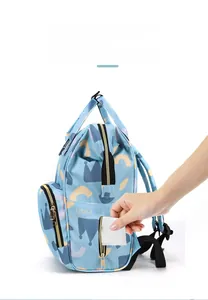 Detail of multi-functional diaper bag showing a convenient side tissue dispenser pocket